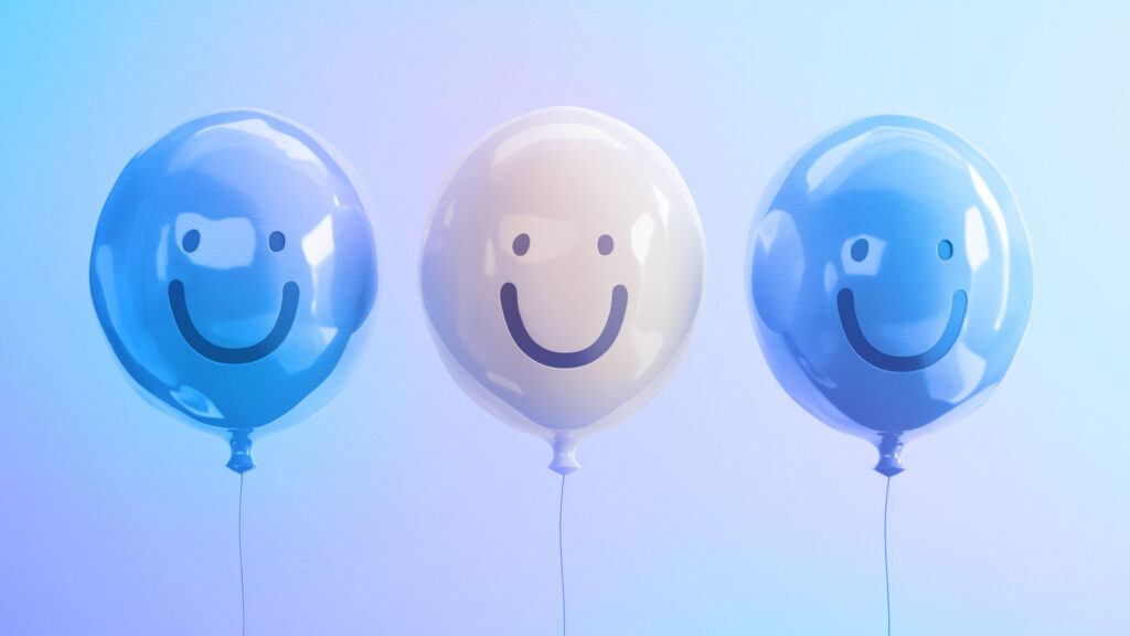 Image of three smiley face balloons, each representing happy employees, satisfied customers, and content shareholders, symbolizing the positive impact of employee empowerment on overall business success.